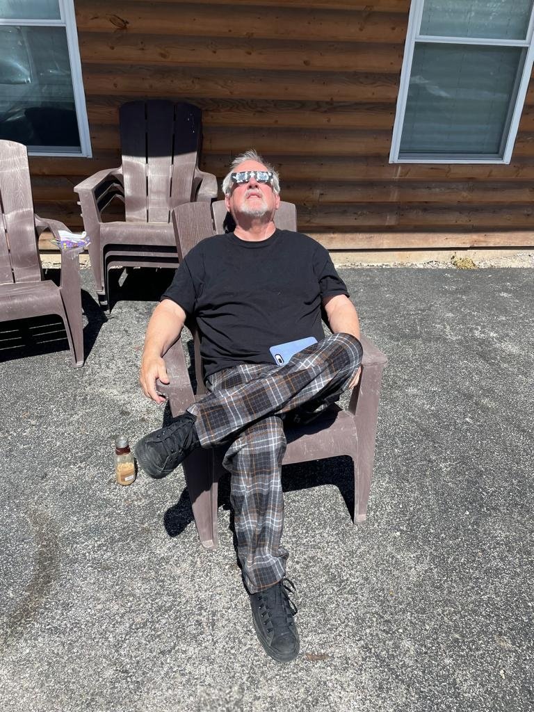 Charlie McGrady outside his house in Gillespie, Illinois, wearing eclipse glasses